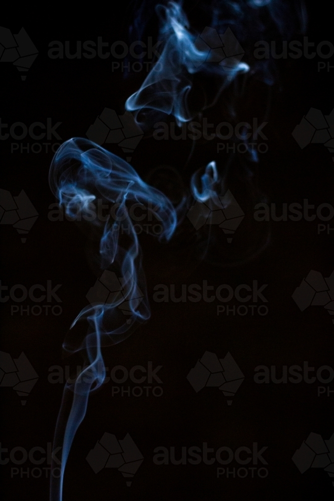 smoke suspended in darkness - Australian Stock Image