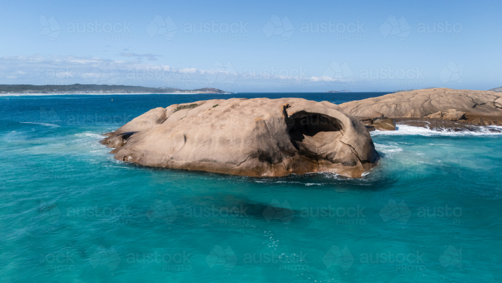 Smooth rounded boulders on a turquoise sea - Australian Stock Image