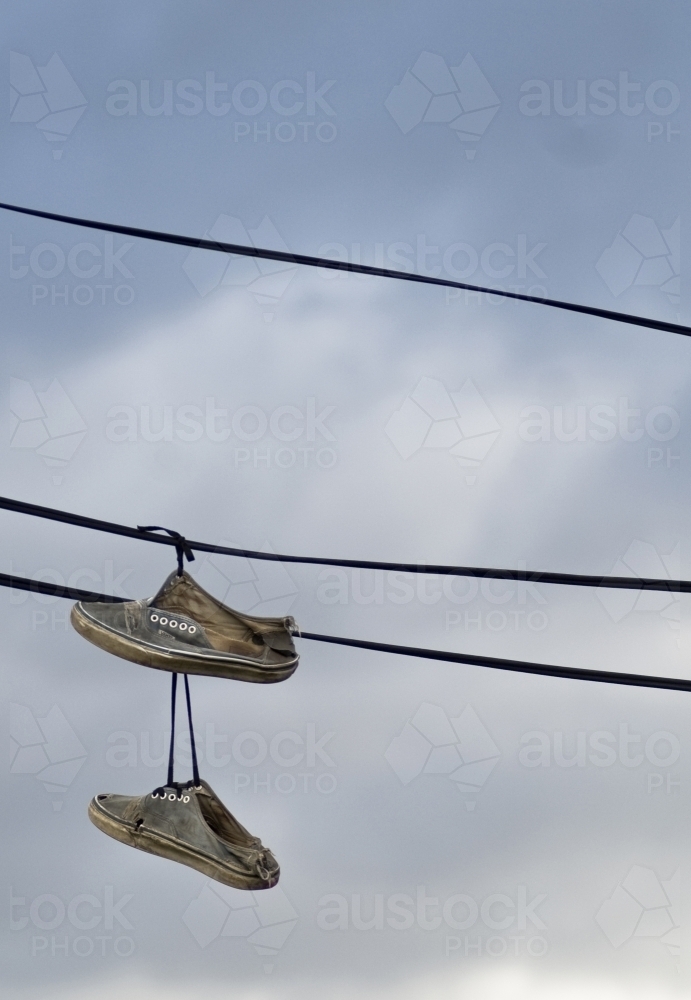 Sneakers hanging off electrical wires - Australian Stock Image