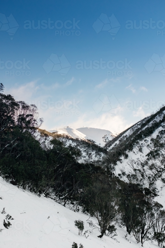 snow covered mountain with blue sky - Australian Stock Image