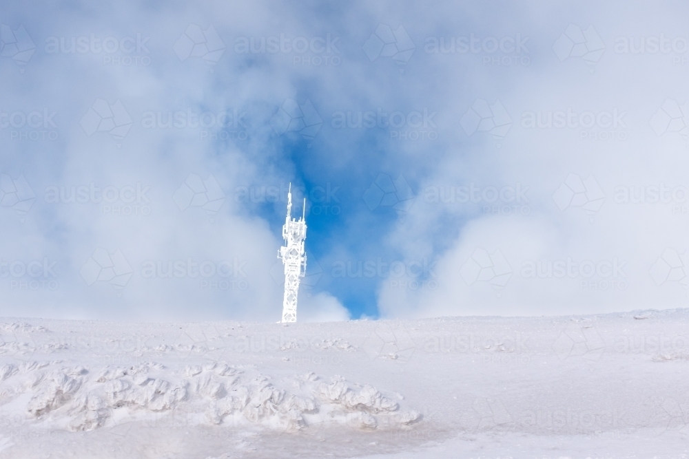 snow covered phone tower, frozen technology concept - Australian Stock Image