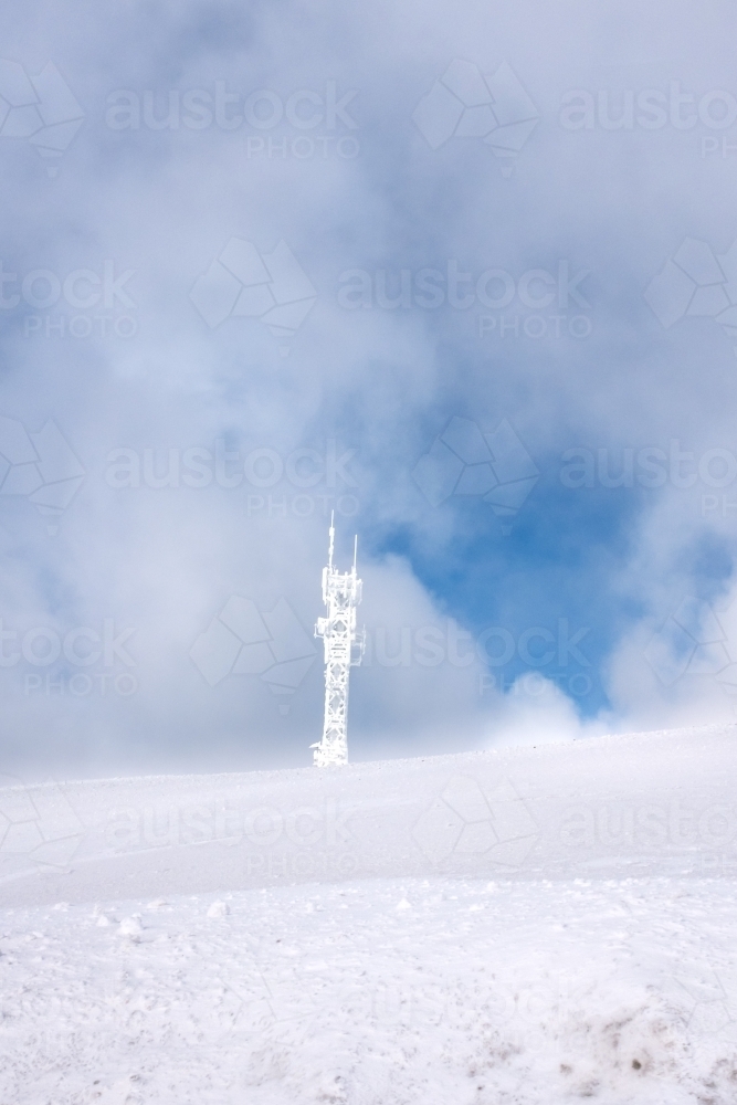 snow covered phone tower, frozen technology concept - Australian Stock Image