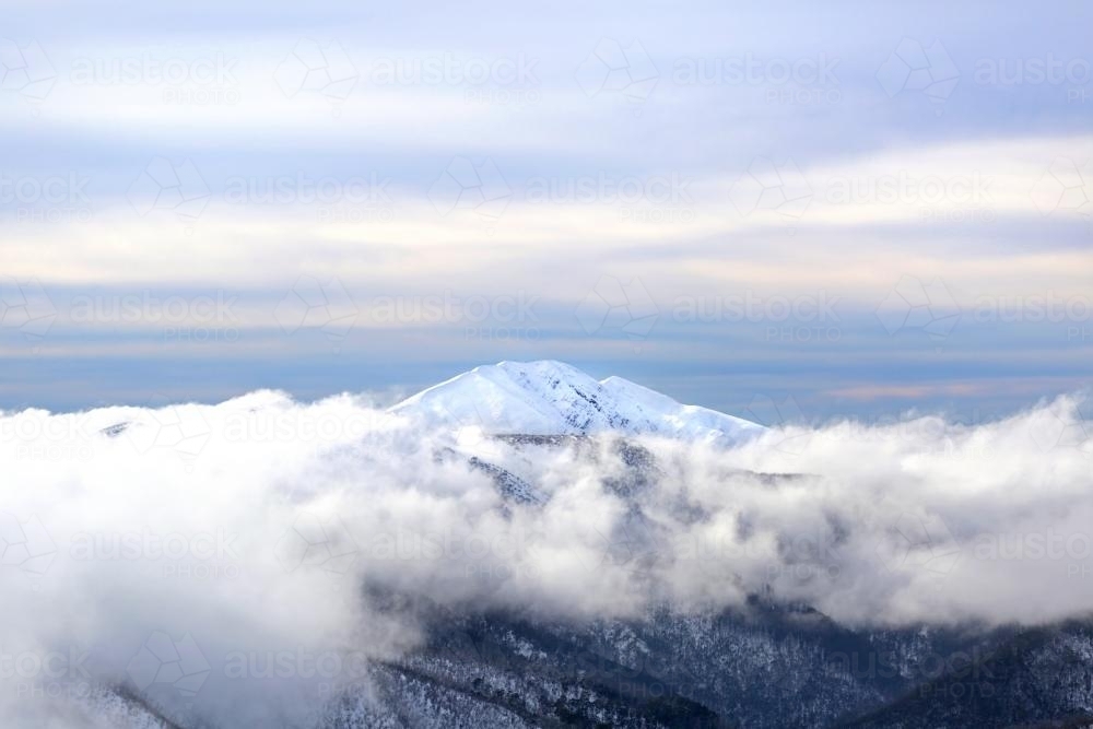 Snow mountain through fog - Australian Stock Image