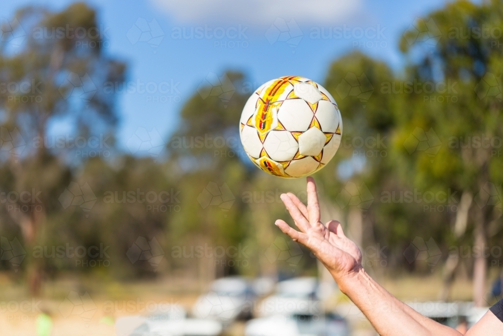 Image of Soccer ball balancing on finger - Austockphoto