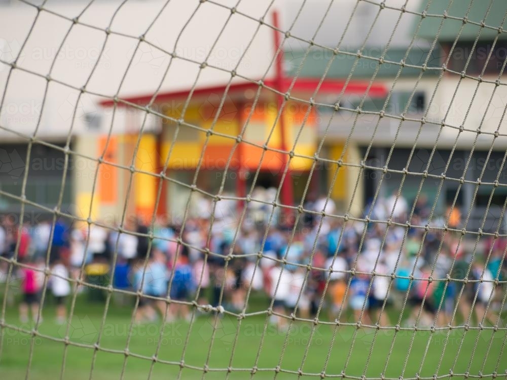 Soccer net with out of focus crowd in the background - Australian Stock Image