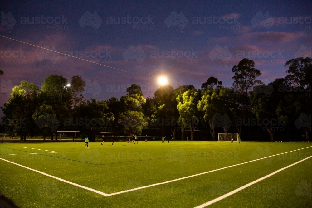 soccer training under lights on an artificial pitch - Australian Stock Image