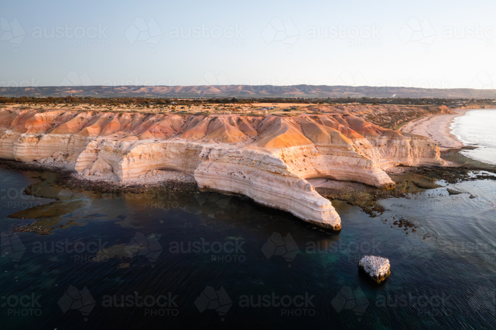 Soft evening light illuminates the sculpted cliffs of Maslin Beach - Australian Stock Image