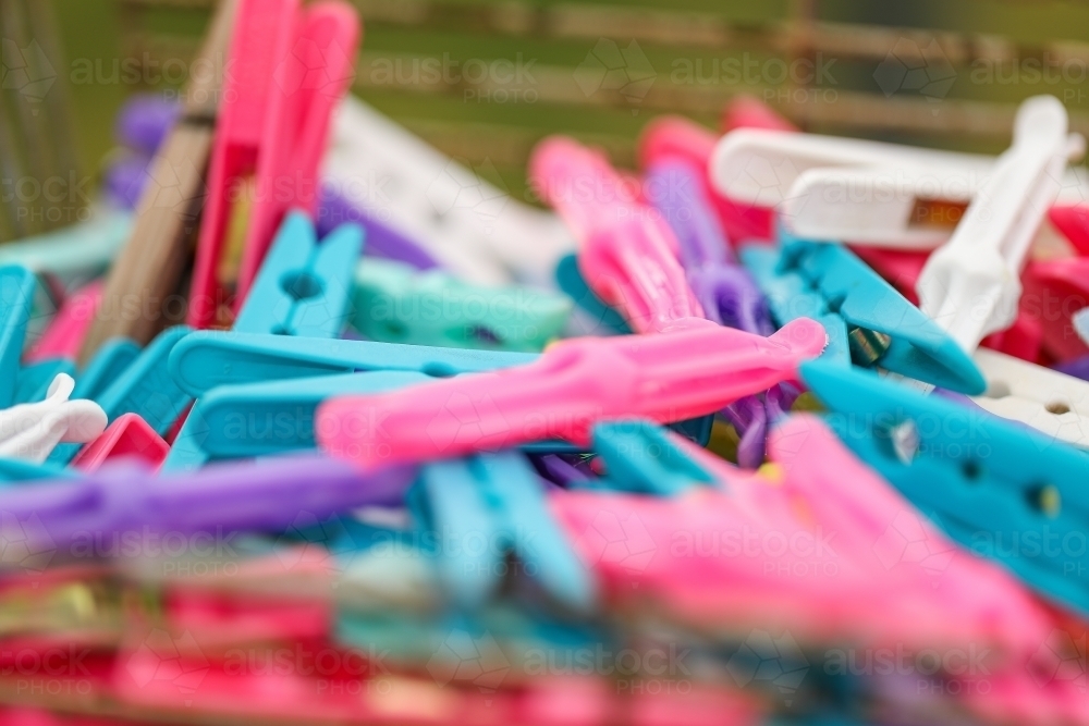 Soft focus close up of brightly coloured laundry pegs - Australian Stock Image