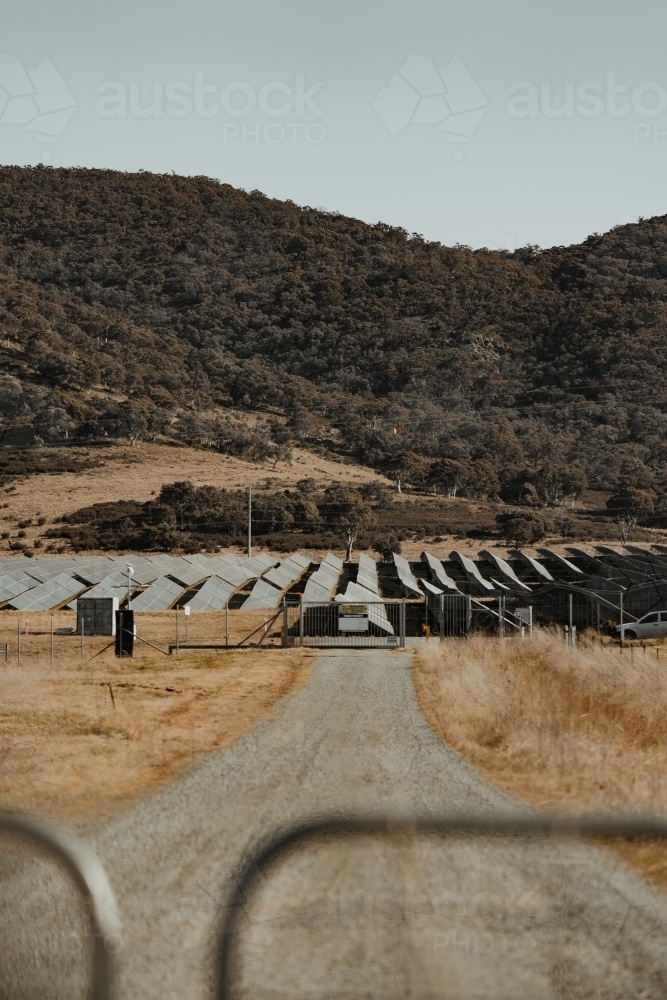Solar farm panels for renewable energy behind a closed gate. - Australian Stock Image
