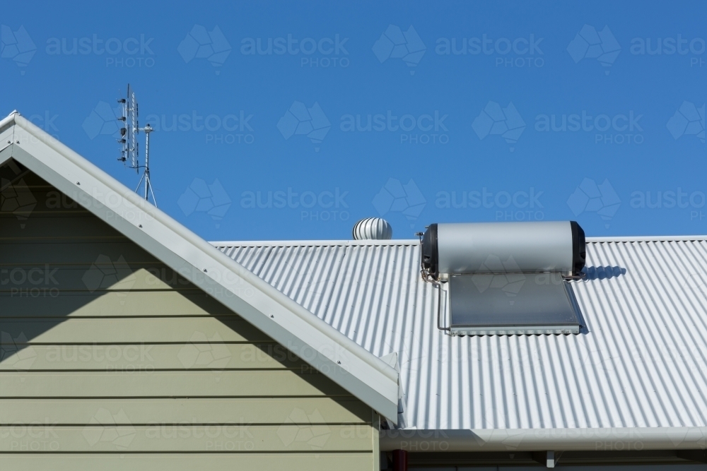 Solar hot water system on a tin roof - Australian Stock Image