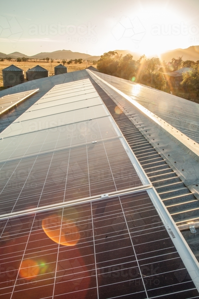 Solar panels and sunlight generating energy to power a farm - Australian Stock Image