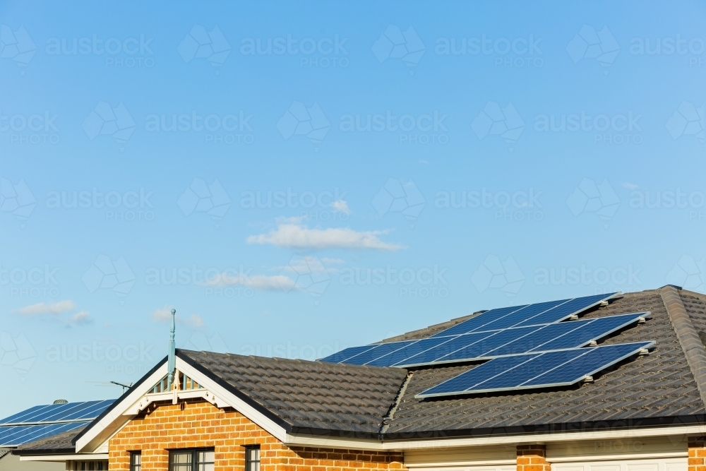 Solar panels covering tiled roof of townhouse - Australian Stock Image