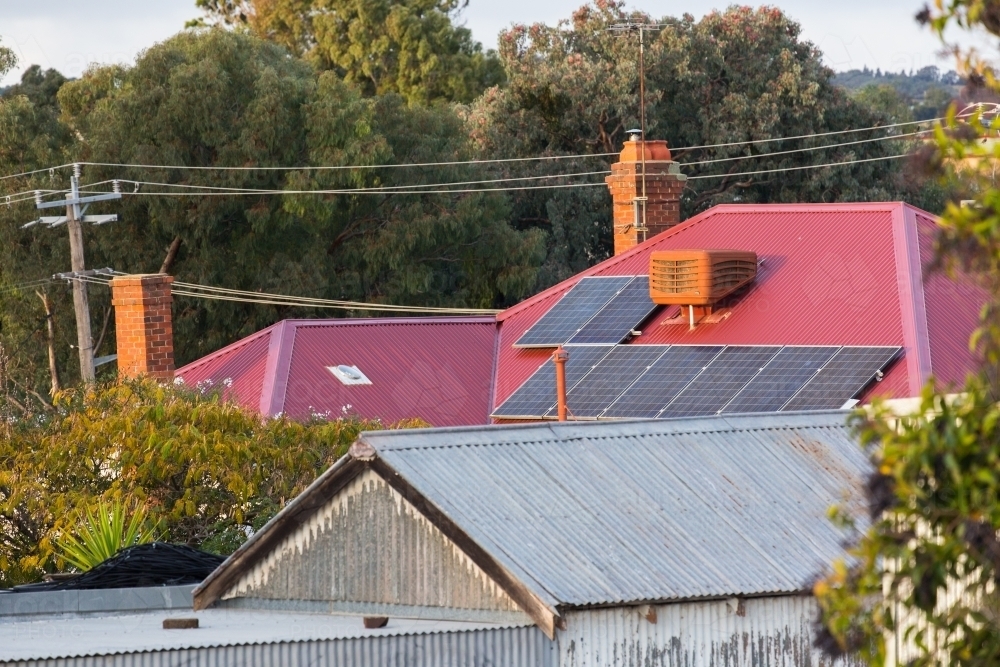 solar panels on a corrugated roof in a rural town - Australian Stock Image