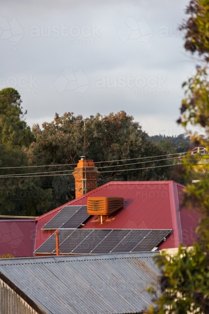 solar panels on a corrugated roof in a rural town - Australian Stock Image