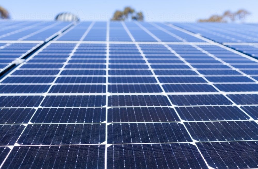 Image of Solar panels on a house roof generating energy in sunlight