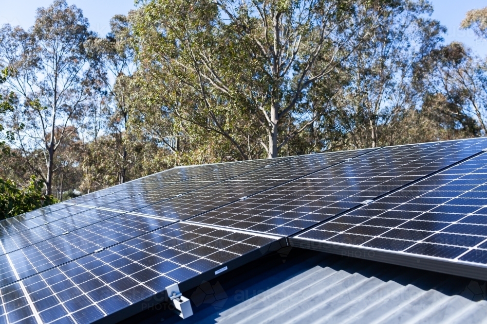 Image of Solar panels on a house roof generating energy in sunlight ...