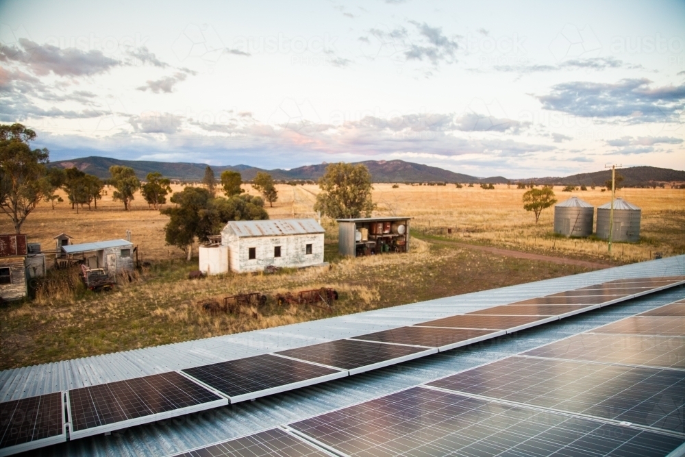 Solar panels on a shed roof generating energy on a country farm - Australian Stock Image