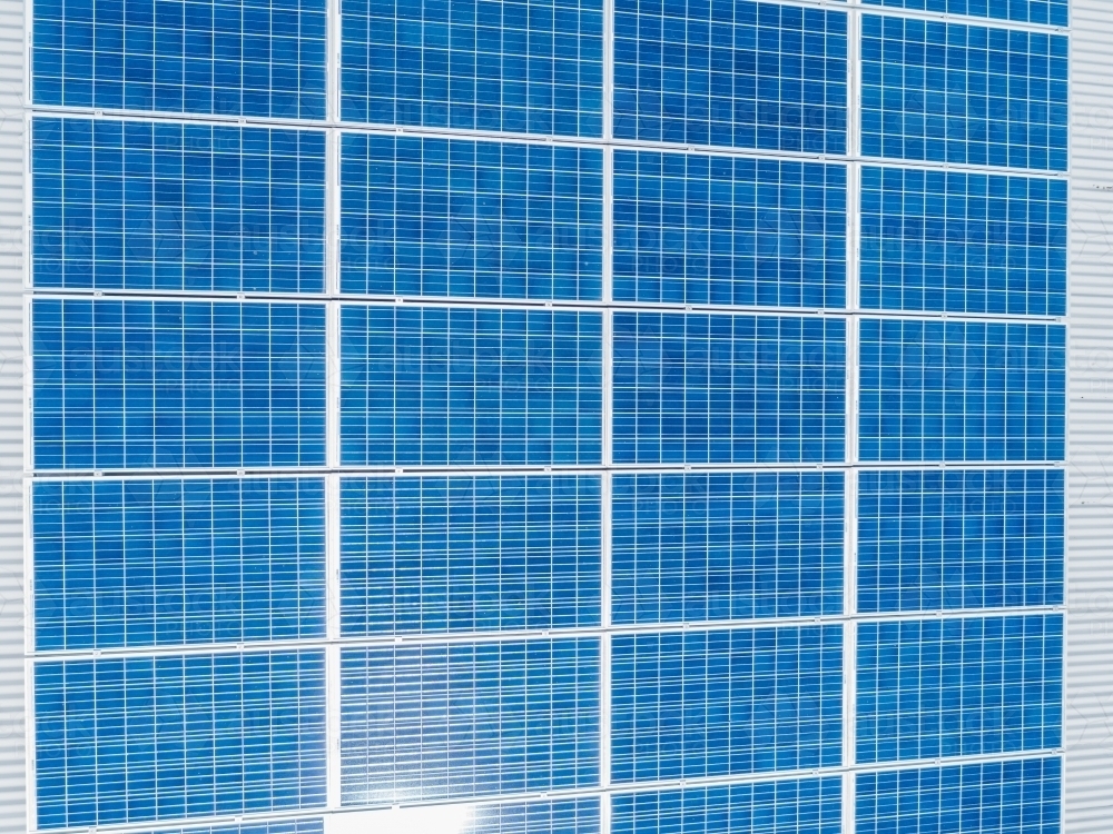 Solar panels on roof of business in sunlight - Australian Stock Image