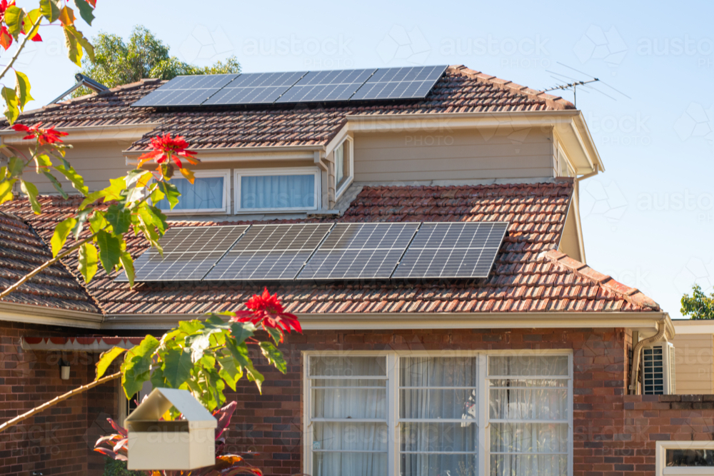 solar panels on tiled roof of house - Australian Stock Image