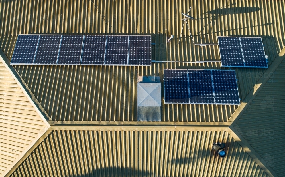 Image of Solar panels on tin roof of house from above - Austockphoto