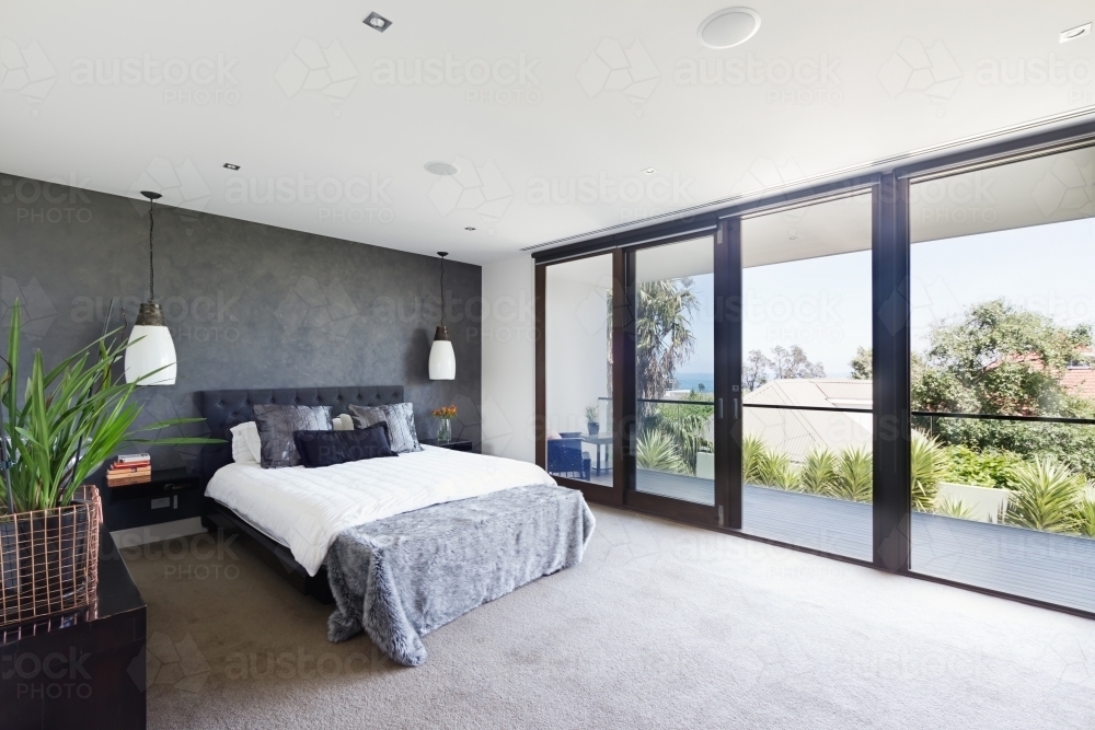 Spacious interior of designer master bedroom in luxury Australian home - Australian Stock Image