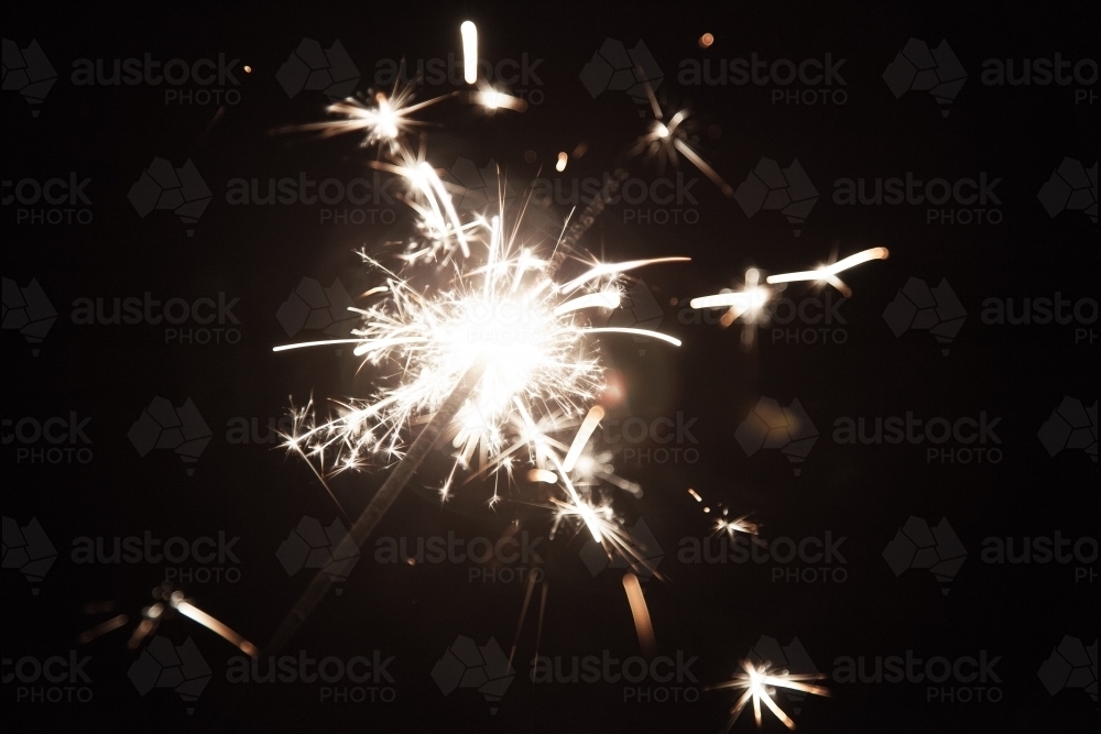 Sparkler shining in the darkness on a bonfire night - Australian Stock Image