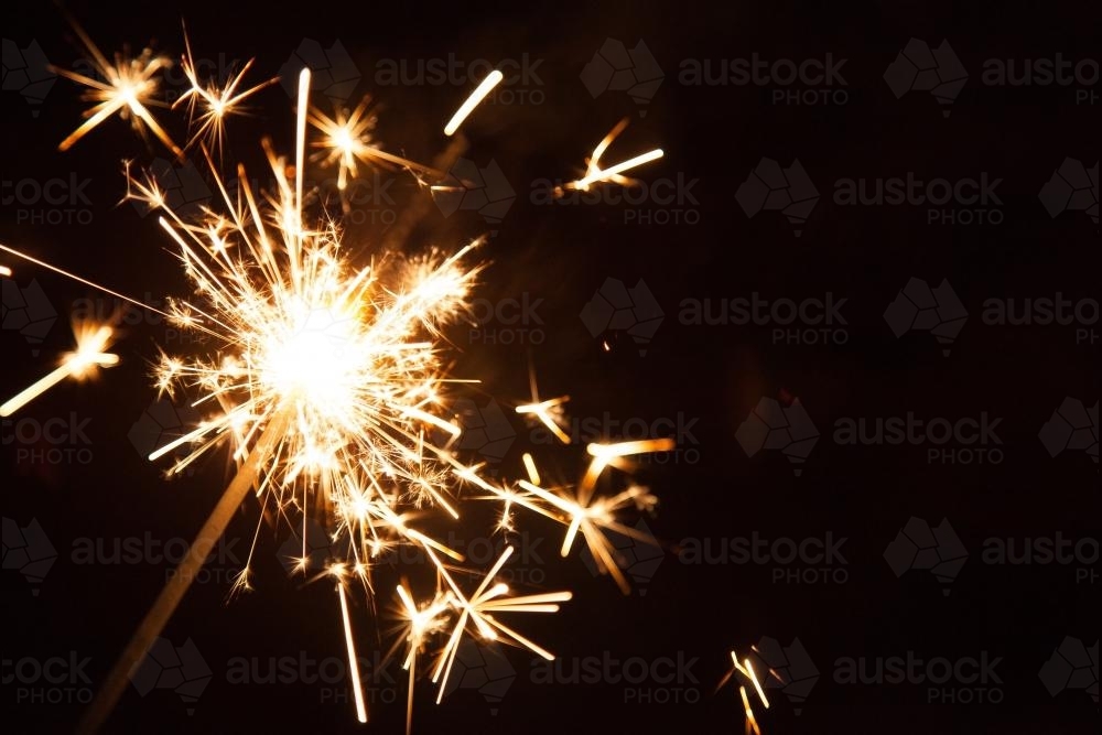 Sparkler shooting out sparks - Australian Stock Image