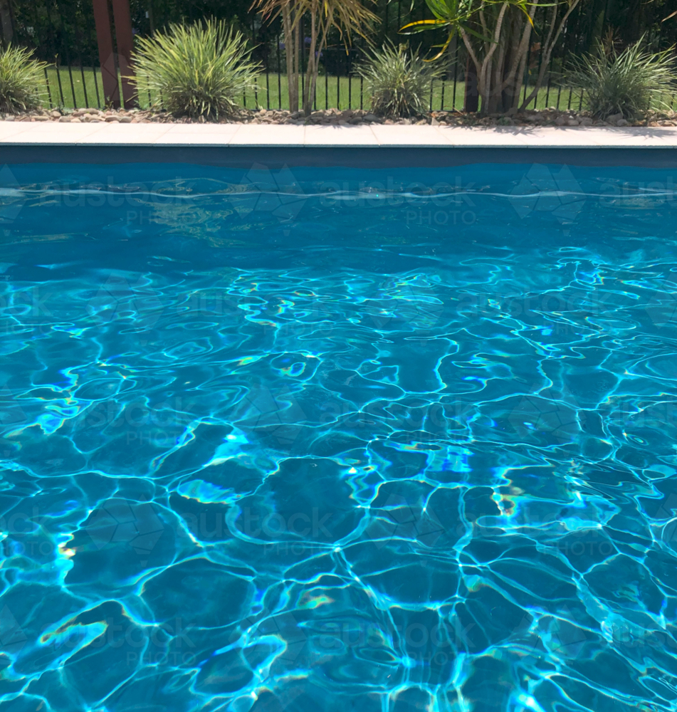 Sparkling blue pool water in backyard - Australian Stock Image