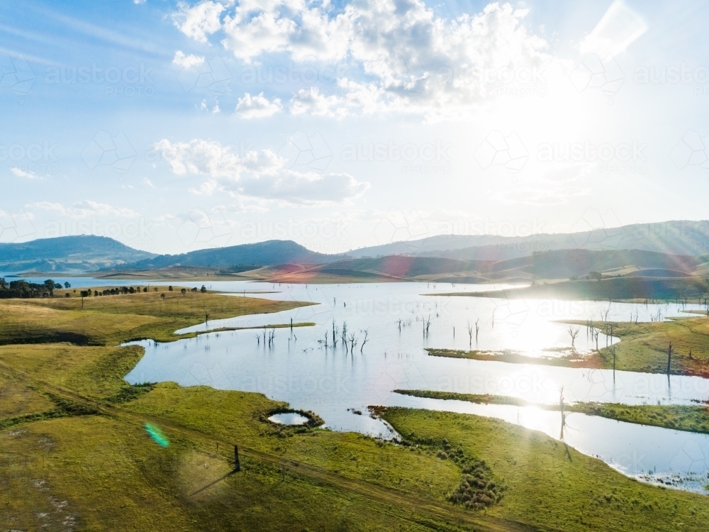 Sparkling light over reservoir and rural landscape, singleton's water supply - Australian Stock Image