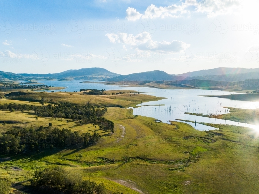 Image of Sparkling light over reservoir and rural landscape Singleton's water supply Austockphoto