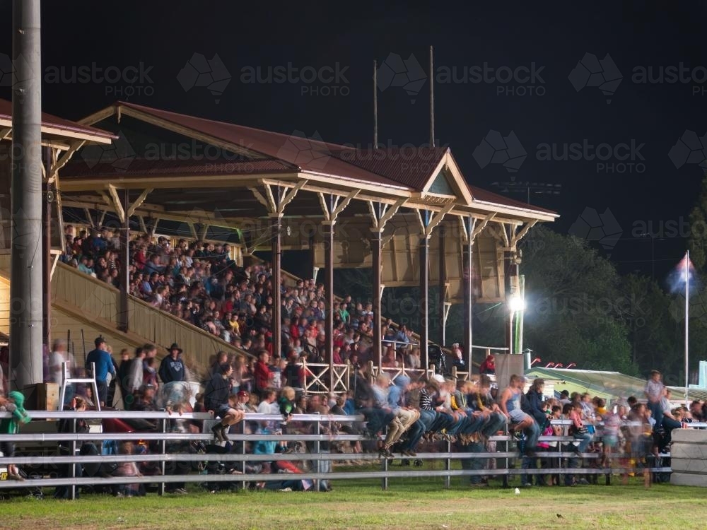 Spectators in a grandstand at night - Australian Stock Image