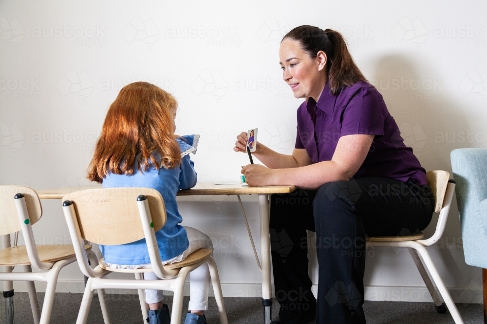 Speech pathologist working with child and picture cards - Australian Stock Image