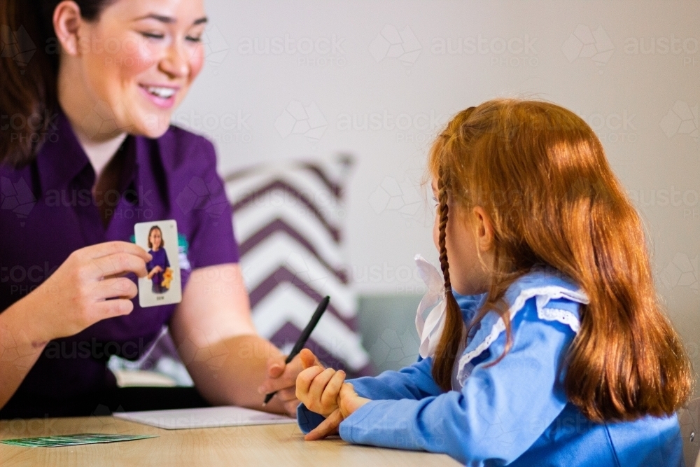 Speech pathologist working with child and picture cards - Australian Stock Image