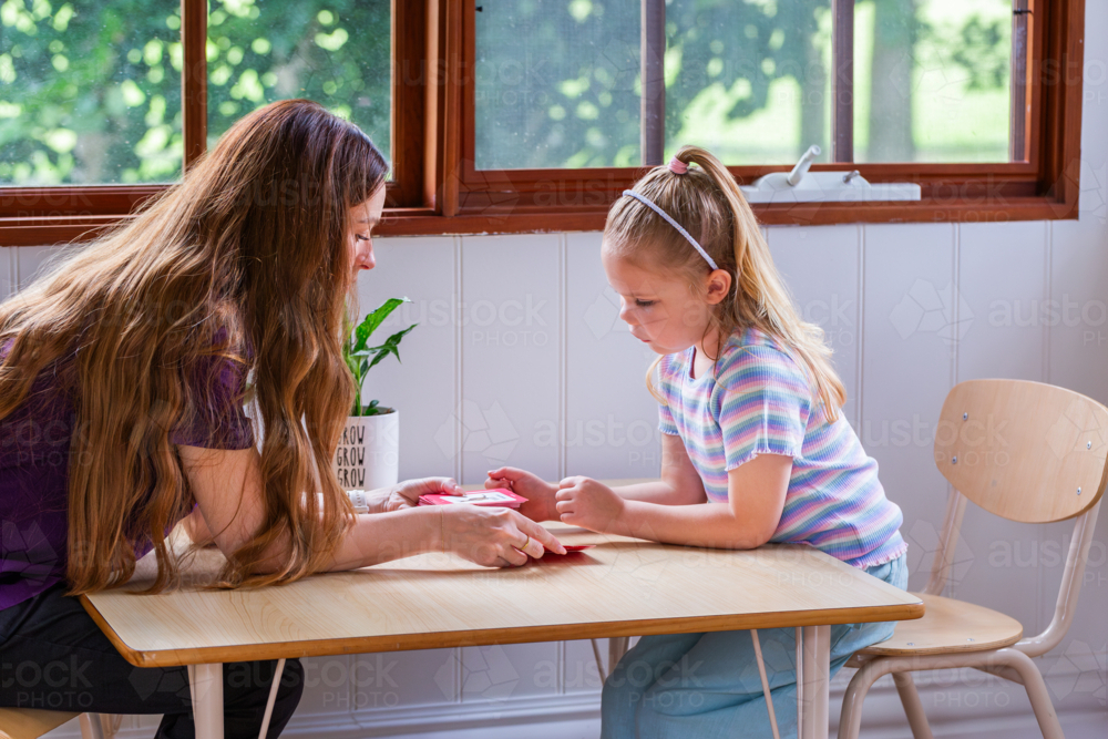 Image of Speech pathologist working with young girl using word flash ...