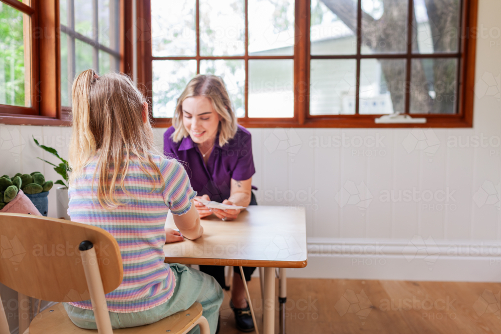 speech pathology clinician and child working together on talking - Australian Stock Image