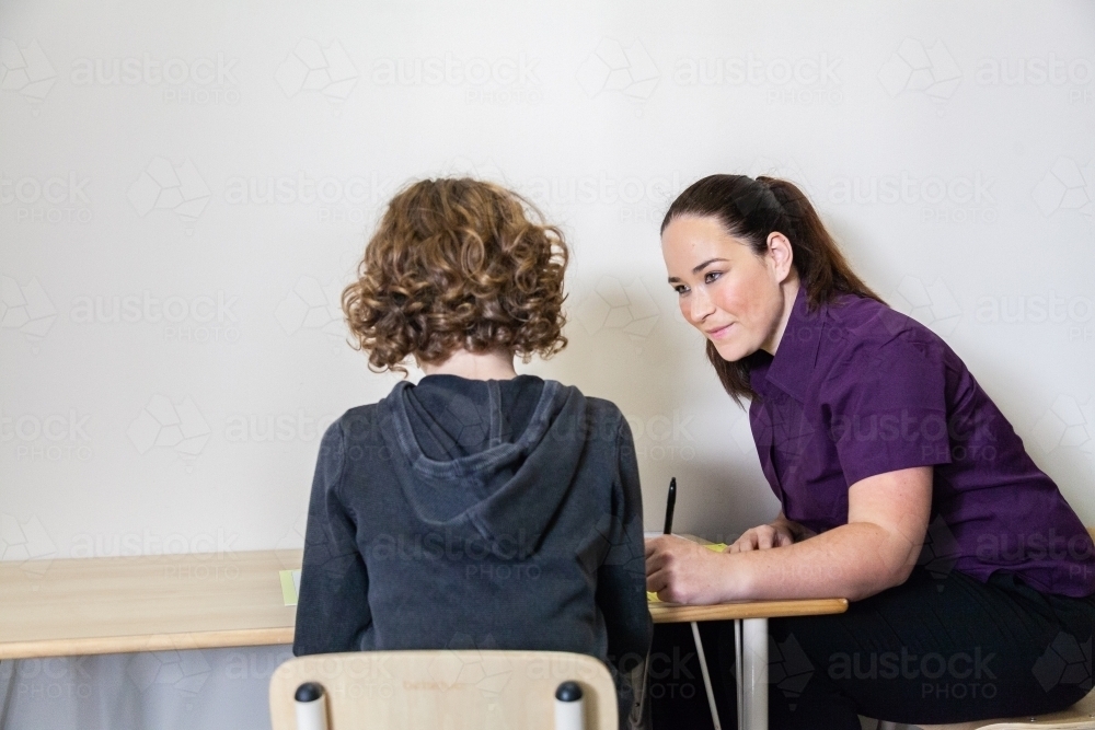 Speech therapist assessing child in clinic - Australian Stock Image