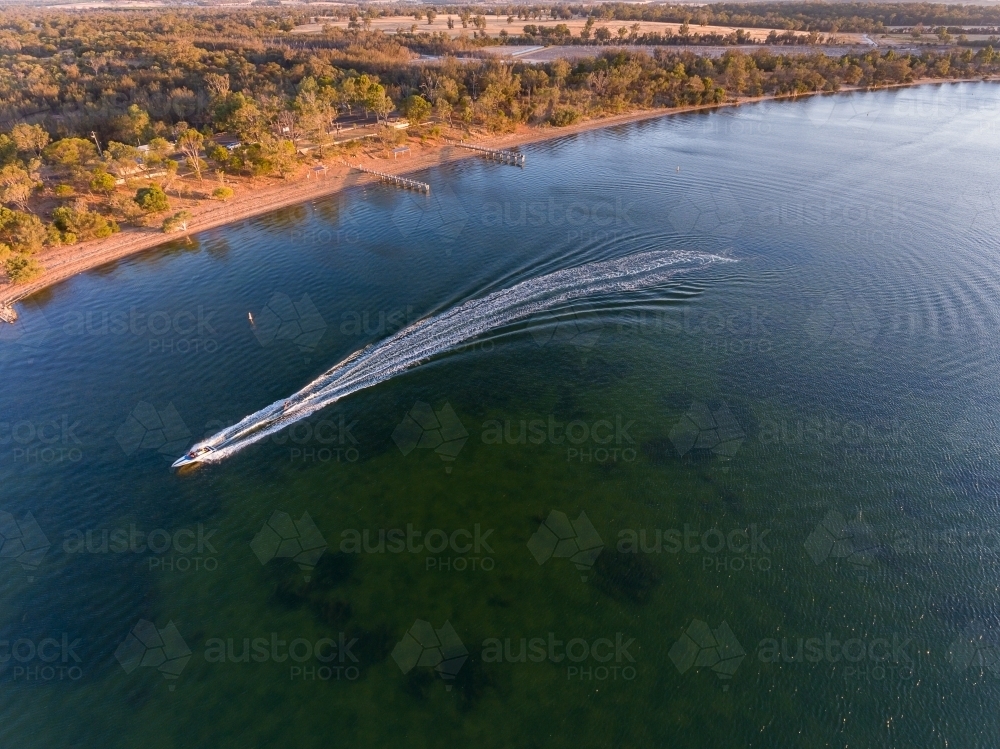 speedboat leaving white wake on lake Towerrinning - Australian Stock Image