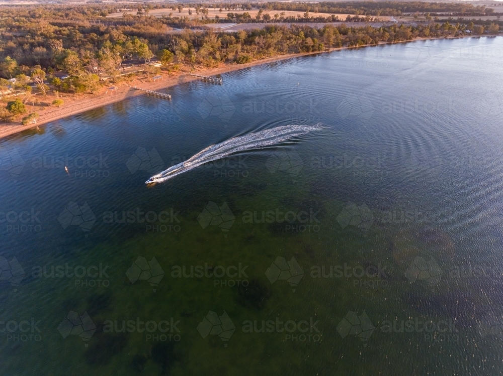 speedboat leaving white wake on lake Towerrinning - Australian Stock Image
