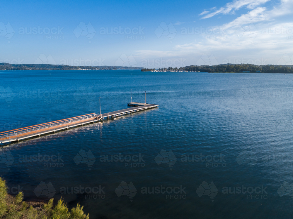 Speers Point Public Jetty in blue water of Cockle Bay in Newcastle - Australian Stock Image