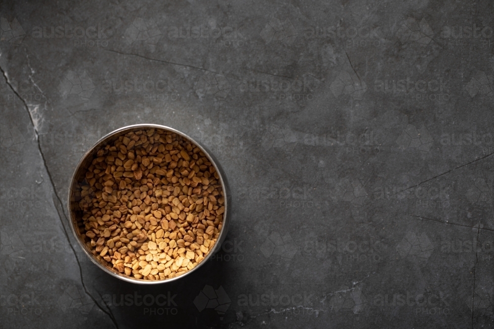 Spice tin of fenugreek seeds - Australian Stock Image