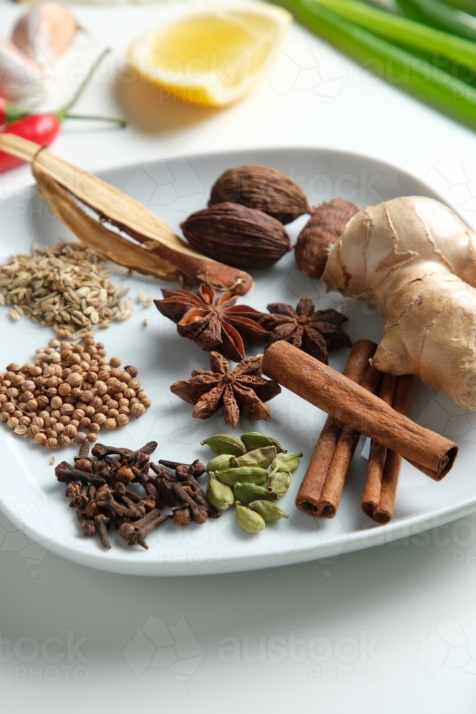Spices and herbs on white table - Australian Stock Image