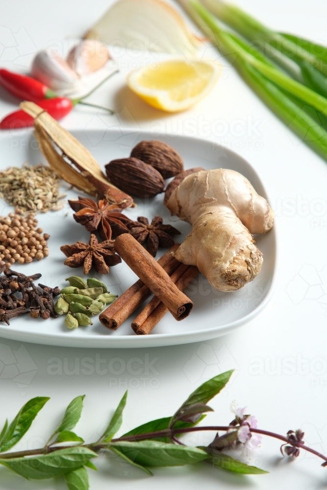 Spices and herbs on white table - Australian Stock Image