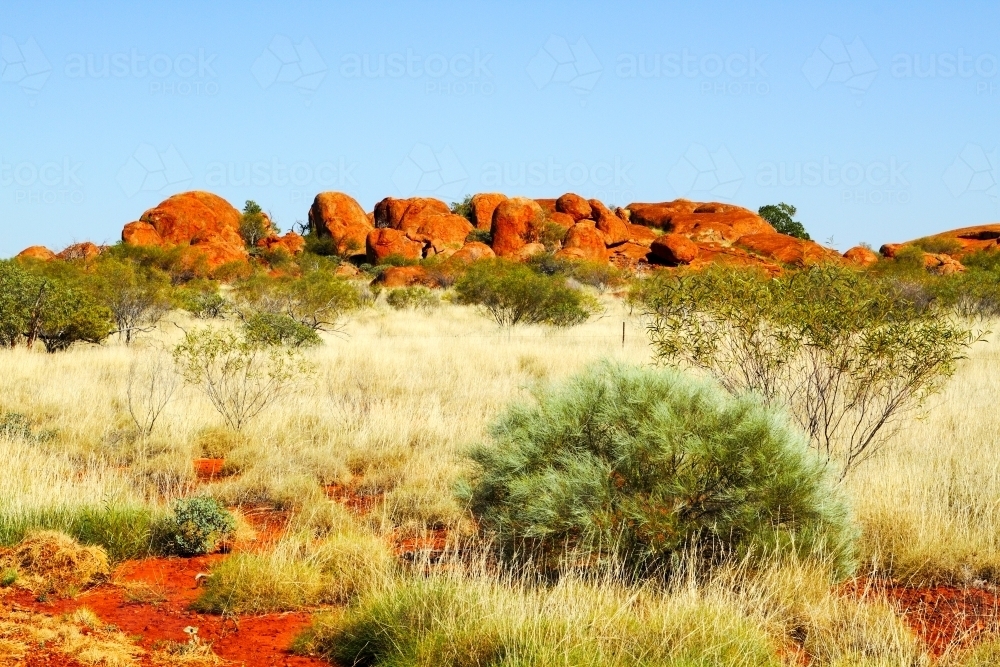 Spinifex and boulders - a highway view in the Pilbara - Australian Stock Image