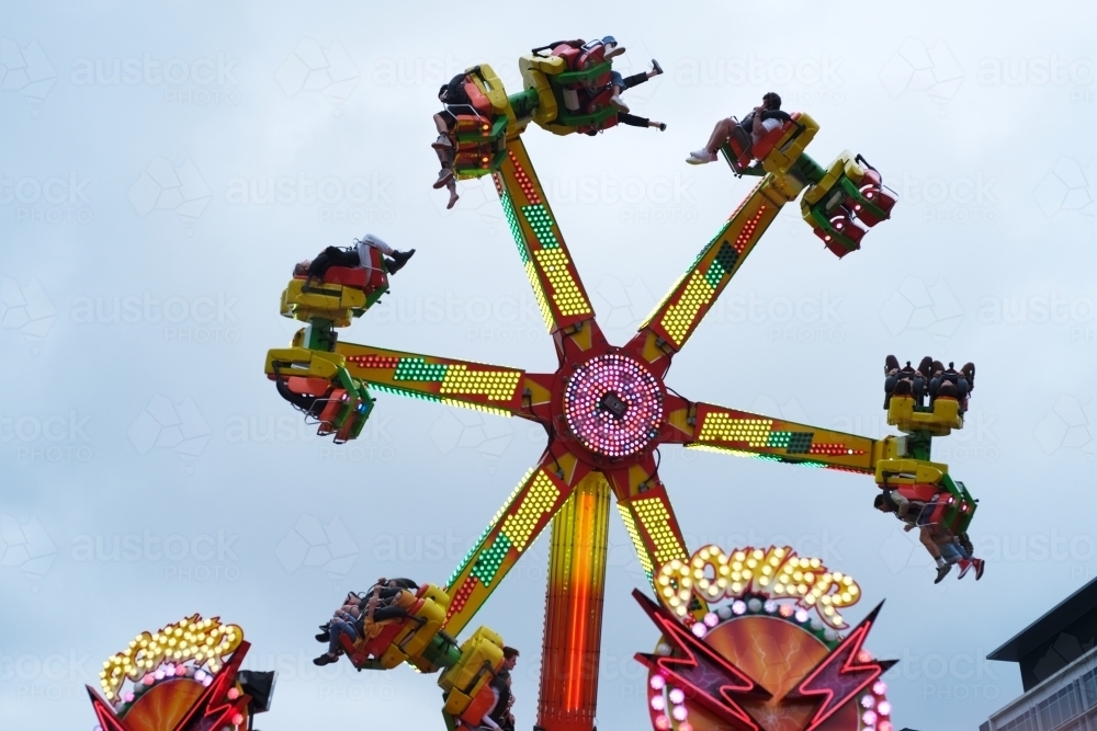 Image of Spinning ride in motion at the carnival - Austockphoto