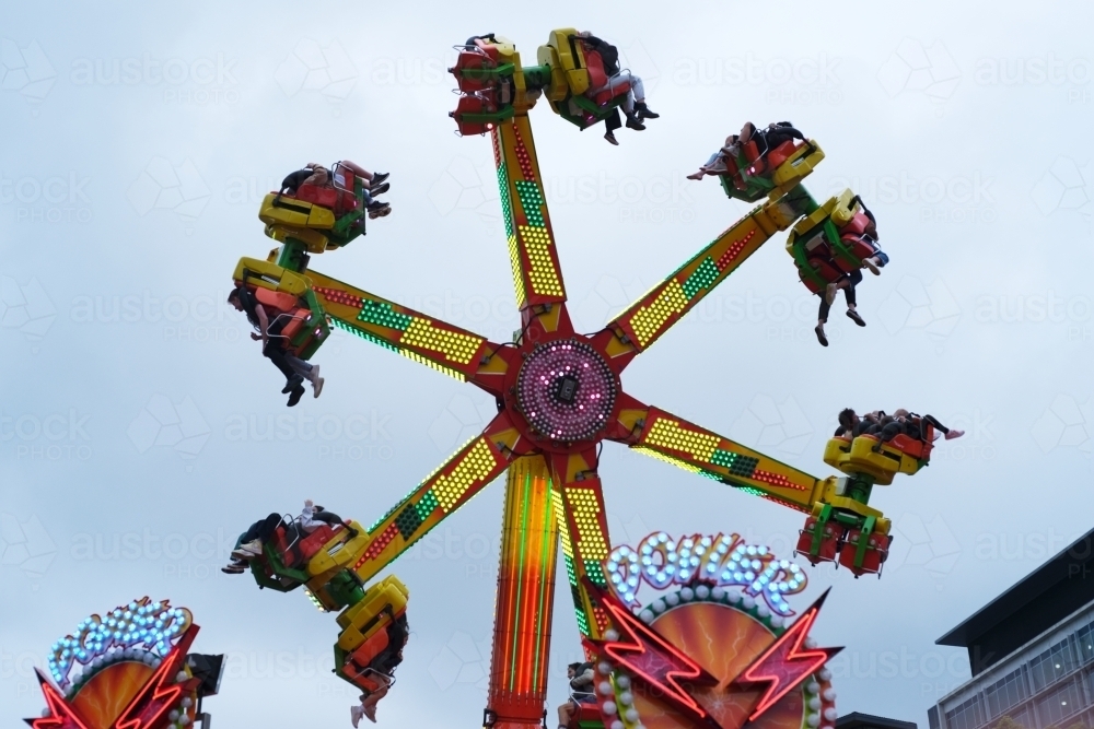 Image of Spinning ride in motion at the carnival - Austockphoto