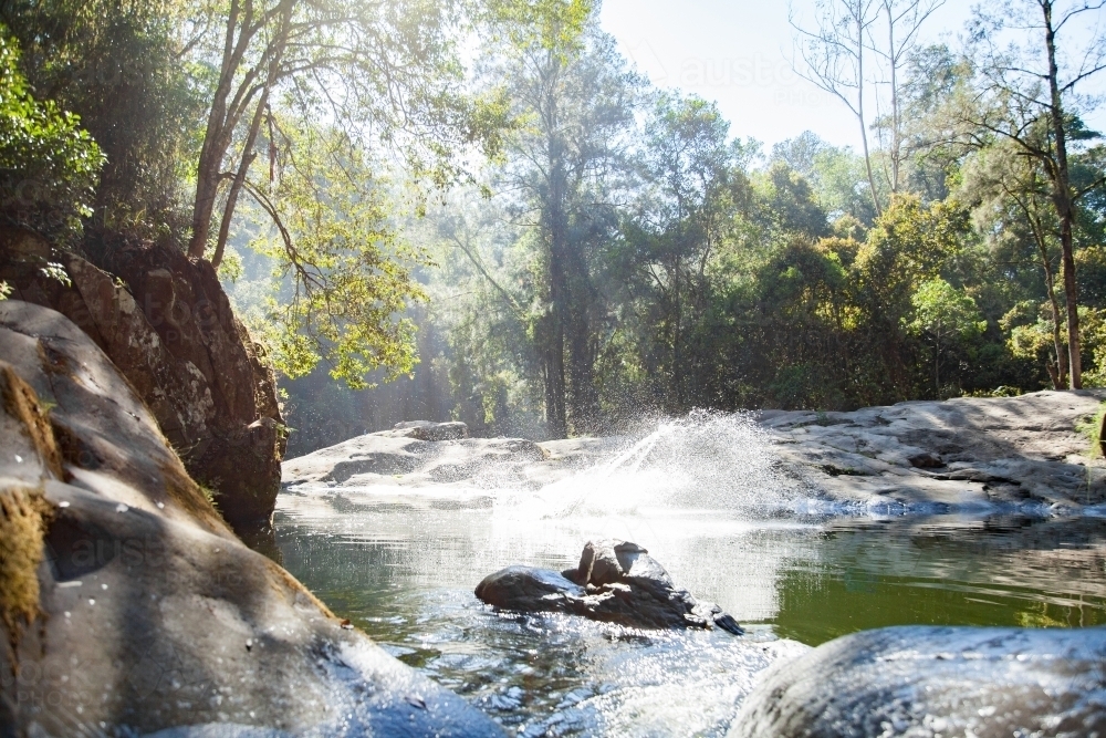 Splash and spray of water in creek on beautiful morning - Australian Stock Image