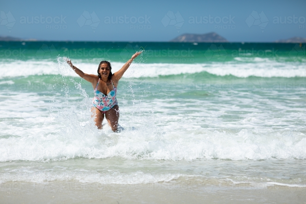 splashing in the shallows at Middleton Beach - Australian Stock Image