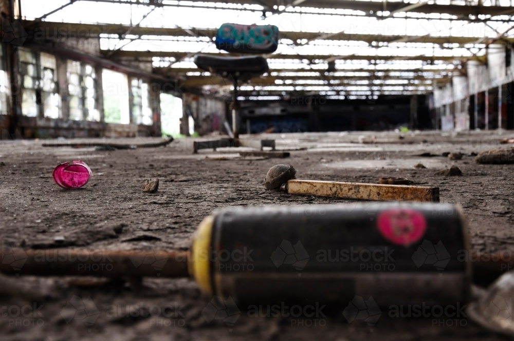Spray can in abandoned warehouse - Australian Stock Image