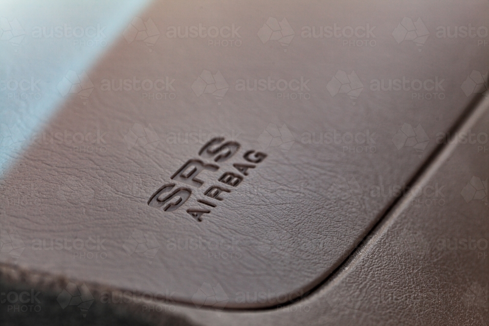 Image of SRS AIRBAG on car dashboard near passenger seat with copy