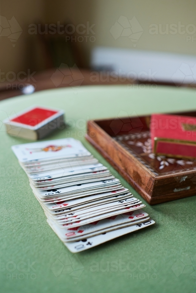 Image of Stack of cards on card table Austockphoto